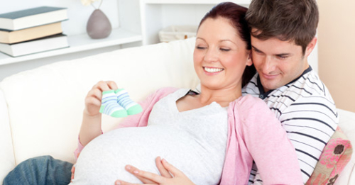 a little girl holding a baby