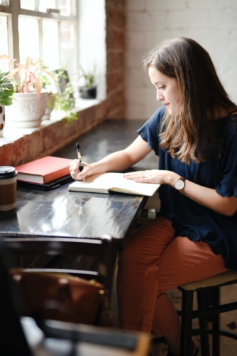 a woman sitting at a table using a laptop